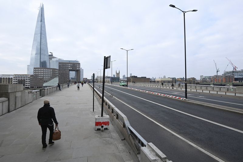 &copy; Reuters. People cross London Bridge during the morning rush hour, on the anniversary of Britain's first coronavirus disease (COVID-19) lockdown, in London, Britain, March 23, 2021. REUTERS/Toby Melville/File photo