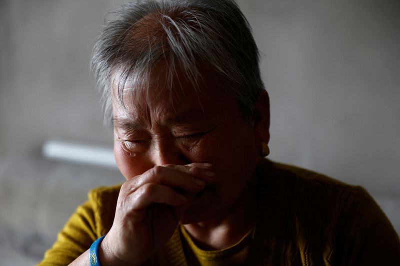 &copy; Reuters. Home buyer Men Xia, 73, reacts during an interview with Reuters at an unfinished residential building of the Gaotie Wellness City complex in Tongchuan, Shaanxi province, China September 12, 2023. REUTERS/Tingshu Wang