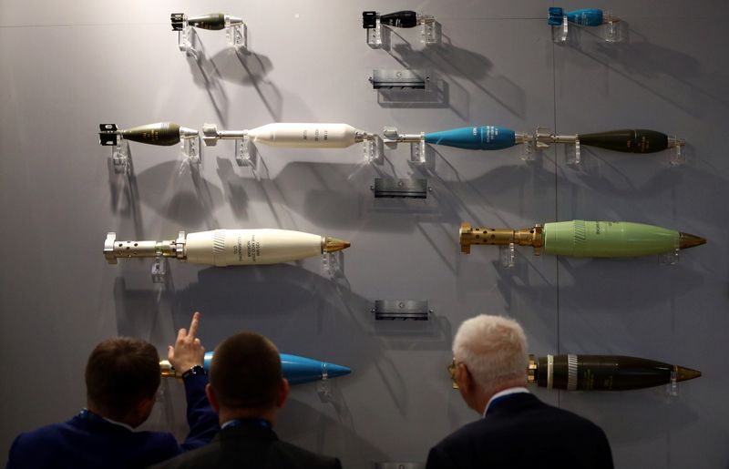 &copy; Reuters. FILE PHOTO: Visitors look at ammunition on display at the Defence and Security Equipment International trade show in London, Britain, September 12, 2017. REUTERS/Hannah McKay