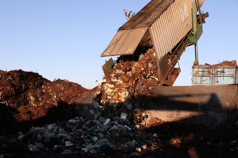 &copy; Reuters. FILE PHOTO: A large truck container dumps food scraps collected from the city of San Francisco into the presorting area before being processed at Recology Blossom Valley Organics North near Vernalis, California, U.S., November 10, 2022.  REUTERS/Brittany 