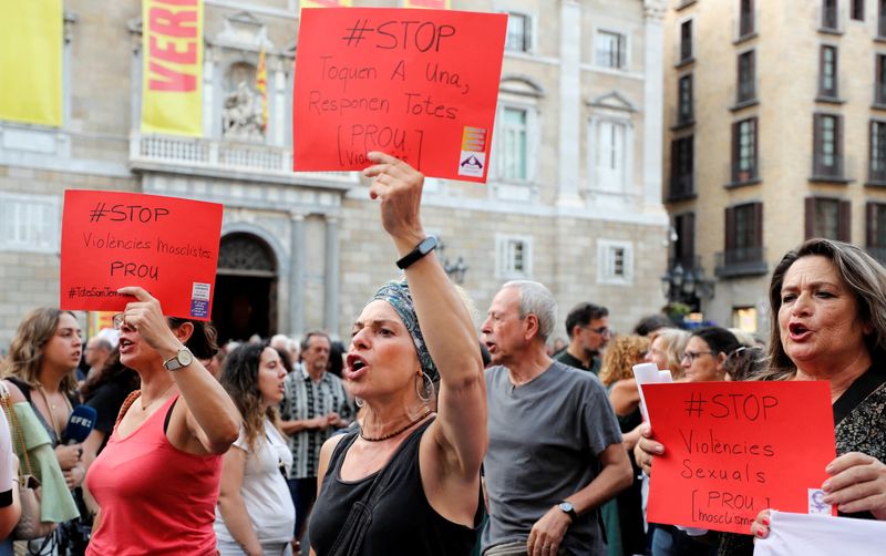 &copy; Reuters. Women hold placards, depicting red card in football, that read "Stop Violence against Women" during a protest against Royal Spanish Football Federation President Luis Rubiales and in support of the player Jenni Hermoso at Sant Jaume Square in Barcelona, S