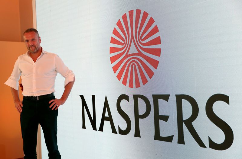 &copy; Reuters. Bob van Dijk, CEO of e-commerce group Naspers, poses for a photograph in front of the company logo after holding a media briefing in Johannesburg, South Africa, October 9, 2019. REUTERS/Siphiwe Sibeko/File photo