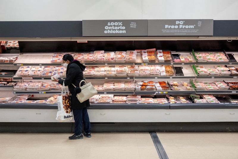 &copy; Reuters. FILE PHOTO: A person shops in the poultry section at a grocery store in Toronto, Ontario, Canada November 22, 2022.  REUTERS/Carlos Osorio/File Photo
