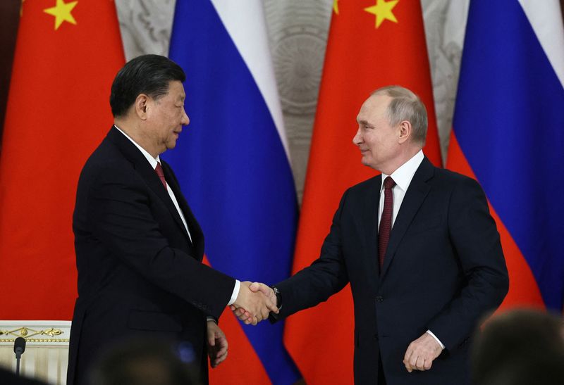 &copy; Reuters. الرئيس الروسي فلاديمير بوتين يصافح نظيره الصيني شي جين بينغ عقب محادثاتهما في الكرملين بموسكو يوم 21 مارس آذار 2023 خلال زيارة شي لروسيا . صورة 