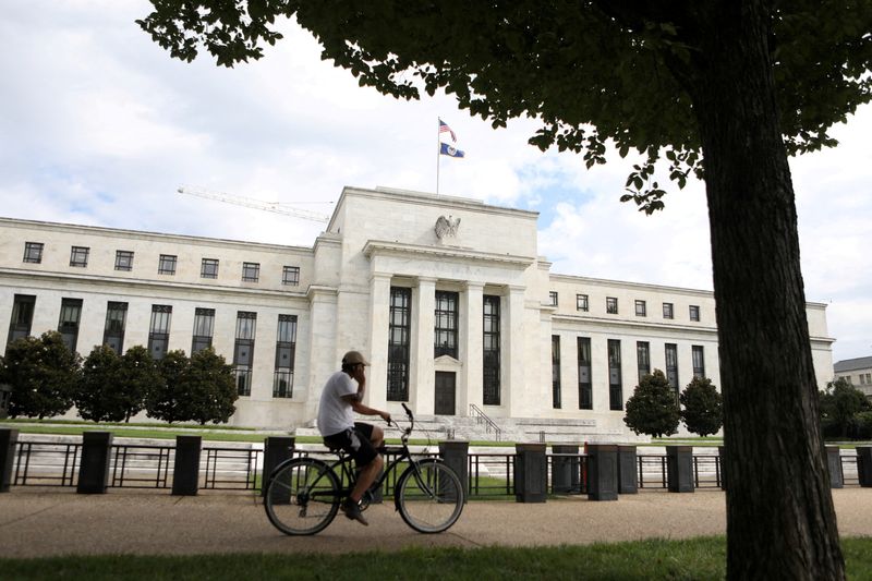 &copy; Reuters. FILE PHOTO: A cyclist passes the Federal Reserve building in Washington, DC, U.S., August 22, 2018. REUTERS/Chris Wattie/File Photo