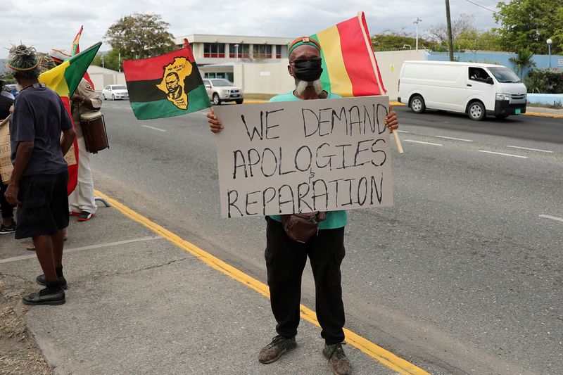 &copy; Reuters. FOTO DE ARCHIVO: Un manifestante sostiene un cartel durante una concentración para exigir que el Reino Unido repare la esclavitud, antes de una visita a Jamaica del duque y la duquesa de Cambridge como parte de su gira por el Caribe, frente a la Alta Com