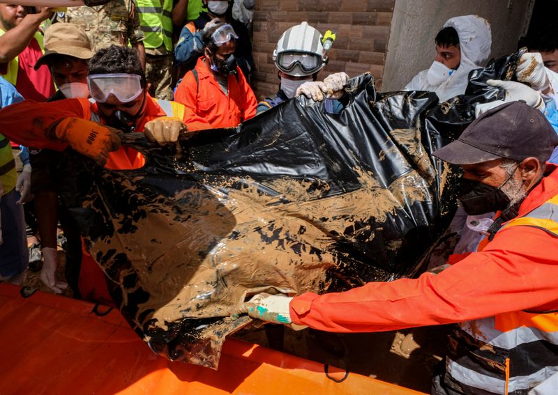 &copy; Reuters. أفراد فرق الإنقاذ يحملون جثة أحد ضحايا الإعصار والفيضانات في مدينة درنة شرق ليبيا يوم 17 سبتمبر أيلول 2023 . تصوير : عصام عمران الفيتوري - رويترز