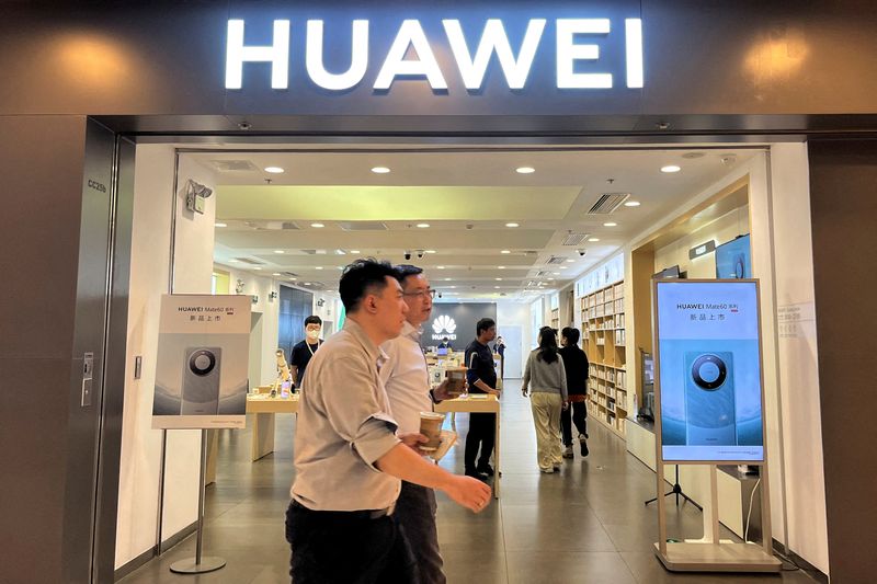 &copy; Reuters. FILE PHOTO: People walk past a Huawei store with advertisements for the Mate 60 series smartphones, at a shopping mall in Beijing, China August 30, 2023. REUTERS/Yelin Mo/File Photo
