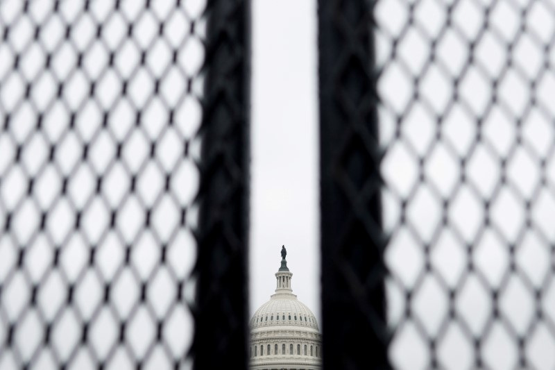 &copy; Reuters. FILE PHOTO: Security fences, erected following the January 6th attack, are seen surrounding the U.S. Capitol in Washington, U.S. March 24, 2021. REUTERS/Carlos Barria