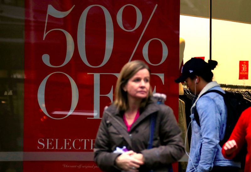 &copy; Reuters. FILE PHOTO: Shoppers walk in front of a retail shop displaying a sale sign in central Wellington, New Zealand, July 3, 2017. Picture taken July 3, 2017.   REUTERS/David Gray/File Photo