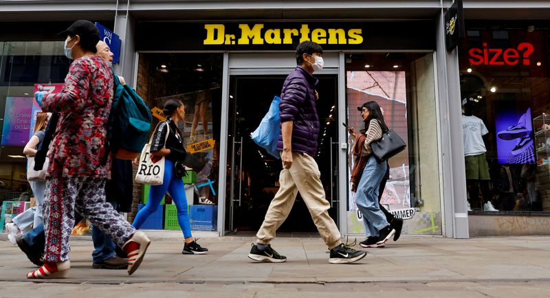 &copy; Reuters. FILE PHOTO: People walk past a Dr. Martens store in Manchester, Britain, May 26, 2023. REUTERS/Jason Cairnduff/File Photo