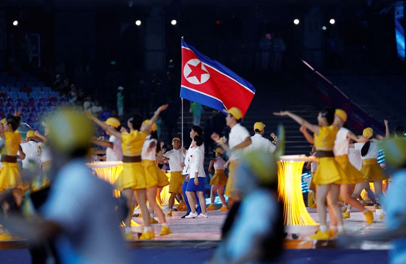 &copy; Reuters. Asian Games - Hangzhou 2022 - Opening Ceremony - Hangzhou Olympic Sports Center Stadium, Hangzhou, China - September 23, 2023 Athletes from North Korea hold their national flag at the Opening Ceremony REUTERS/Tingshu Wang