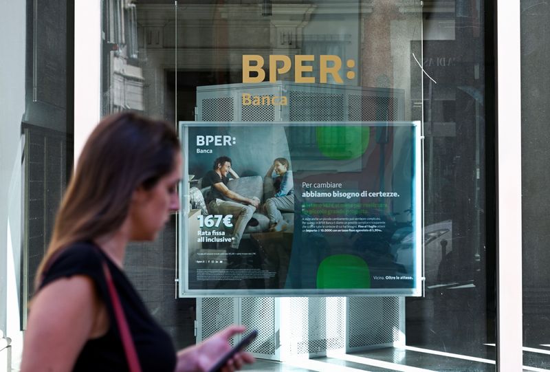 &copy; Reuters. FILE PHOTO: A woman walks past the logo of BPER Banca bank as CEO Piero Montani presents a new business plan, in Milan, Italy, June 10, 2022. REUTERS/Flavio Lo Scalzo/File Photo
