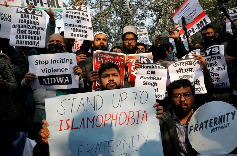 &copy; Reuters. Demonstrators hold placards during a protest against what they say is hate speech against Muslims by Hindu leaders, in New Delhi, India, December 27, 2021. REUTERS/Adnan Abidi/File Photo