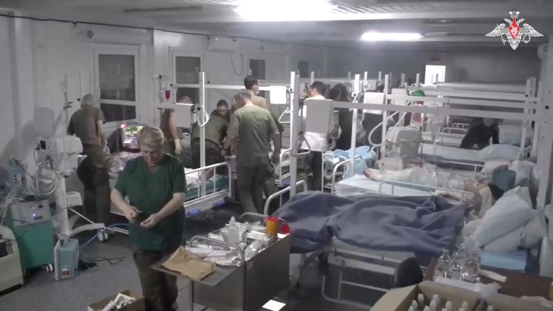 &copy; Reuters. Medics of the Russian peacekeeping troops treat people injured in an explosion at a fuel depot outside Stepanakert, in an unknown location in Nagorno-Karabakh, a region inhabited by ethnic Armenians, in this still image from video published September 26, 