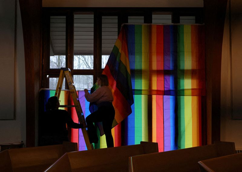 &copy; Reuters. FILE PHOTO: Volunteers hang LGBTQ Pride flags in the windows of the Community Church of Chesterland as a security precaution ahead of a Drag Show Story Hour at the church in Chesterland, Ohio, U.S., March 31, 2023. REUTERS/Jim Urquhart/File Photo