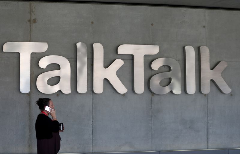 &copy; Reuters. FILE PHOTO: A woman speaks on her phone as she passes a branded logo outside the Talktalk headquarters in London, Britain May 10, 2017. REUTERS/Neil Hall/File Photo
