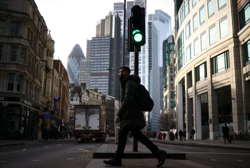 &copy; Reuters. A person walks through the City of London financial district in London, Britain, February 10, 2023. REUTERS/Henry Nicholls/File photo