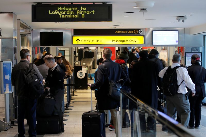 &copy; Reuters. Travelers wait in lines at LaGuardia Airport in New York City after hundreds of flights were grounded or delayed at New York-area airports as more air traffic controllers called in sick on Friday, in one of the most tangible signs yet of disruption from a