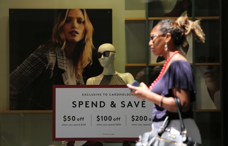 &copy; Reuters. A woman walks past a display promoting discounts in Sydney's central business district (CBD) Australia, February 5, 2018. REUTERS/Daniel Munoz/File photo