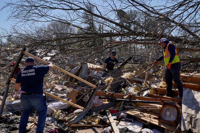 &copy; Reuters. FILE PHOTO: Fire and Rescue team members search for people trapped under the rubble in the aftermath of a tornado, after a monster storm system tore through the South and Midwest on Friday, in Wynne, Arkansas, U.S. April 1, 2023. REUTERS/Cheney Orr/File P