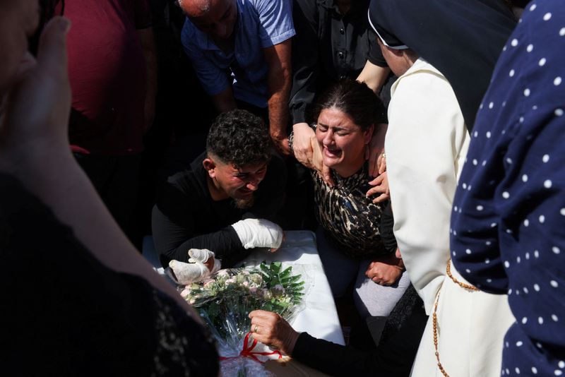 &copy; Reuters. معزون ينتحبون خلال جنازة ضحايا حريق مميت في حفل زفاف في قضاء الحمدانية في العراق يوم الخميس. تصوير: أحمد سعد - رويترز.