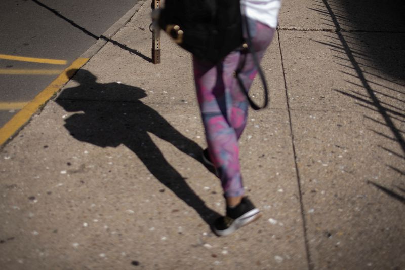 &copy; Reuters. An Ecuadorean asylum seeker who said she was kidnapped and sexually trafficked near the U.S.-Mexico border walks down a street in New Jersey, U.S., on August 18, 2023. REUTERS/Maye-E Wong