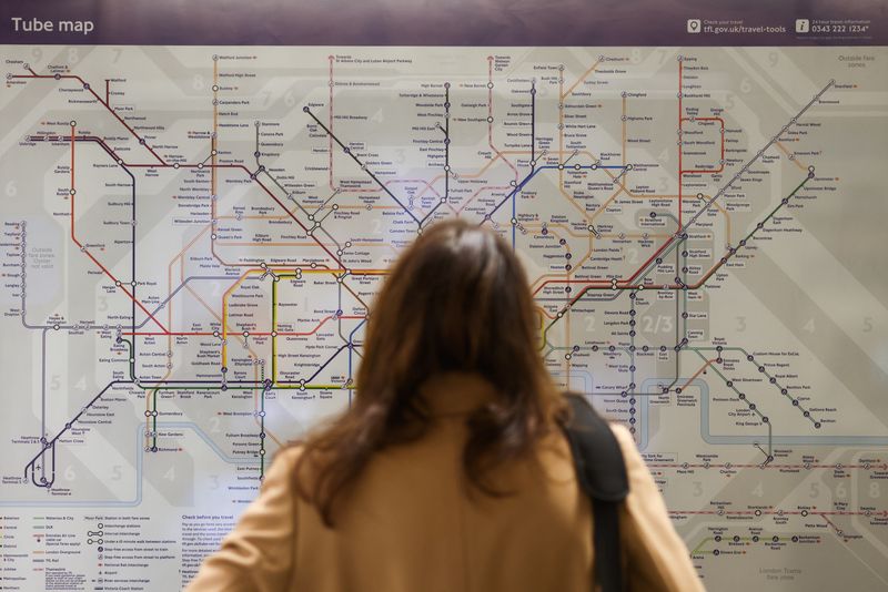 &copy; Reuters. FILE PHOTO: A woman looks at the tube map at the Waterloo underground station during a tube strike, in London, Britain, November 26, 2021. REUTERS/Tom Nicholson/File Photo