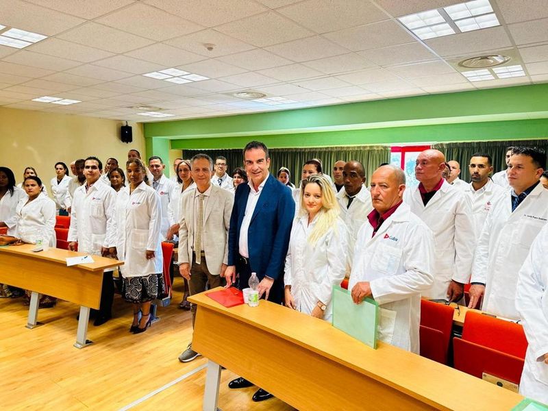 &copy; Reuters. FILE PHOTO:Governor of Italy's Calabria region Roberto Occhiuto poses with Cuban medics whom he has hired to help deal with a shortage of staff in local hospitals, at the University of Calabria in Cosenza, Italy, in this undated picture obtained by Reuter