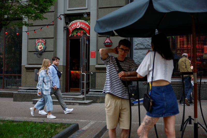 &copy; Reuters. FILE PHOTO: People are seen outside of the Piana Vyshnia (Drunken Cherry) chain's bar in downtown, amid Russia's attack on Ukraine, in Kyiv, Ukraine May 15, 2023. REUTERS/Valentyn Ogirenko/File Photo