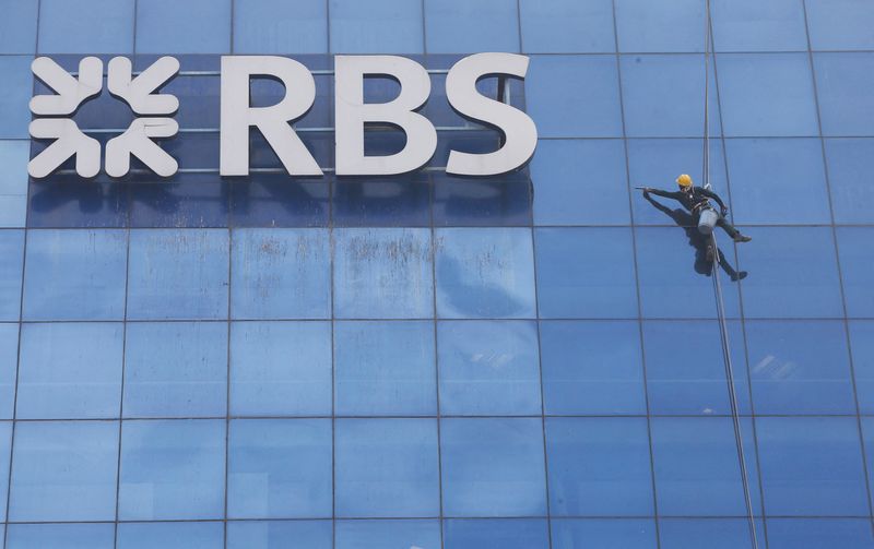&copy; Reuters. FILE PHOTO: A worker cleans the glass exterior next to the logo of RBS (Royal Bank of Scotland) bank at a building in Gurugram on the outskirts of New Delhi, India, September 8, 2017. REUTERS/Adnan Abidi/File Photo