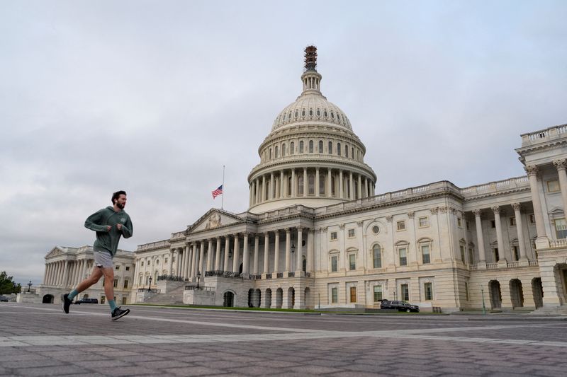 &copy; Reuters. FILE PHOTO: A jogger runs by the U.S. Capitol as the deadline to avert a partial government shutdown approaches at the end of the day on Capitol Hill in Washington, U.S., September 30, 2023. REUTERS/Ken Cedeno/File Photo