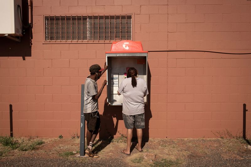&copy; Reuters. Local residents Rosemary and Jonathan use the landline phone booth, as the local phone tower is out of service that day, ahead of a nationwide referendum on Indigenous issues, in Hermannsburg, Australia, September 18, 2023. On October 14, Australians will