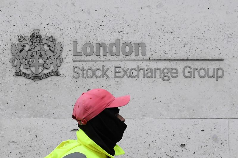 &copy; Reuters. FILE PHOTO: A street cleaning operative walks past the London Stock Exchange Group building in the City of London financial district in London, Britain, March 9, 2020. REUTERS/Toby Melville/File Photo