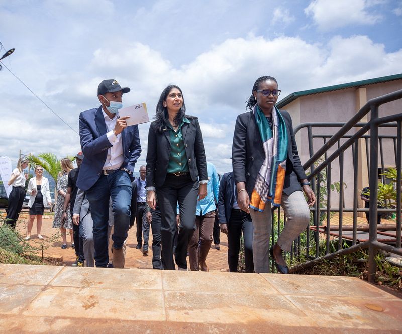 &copy; Reuters. British Home Secretary Suella Braverman walks with Paul Rwigamba, Director of Projects and Property Management and Flora Uwayezu, Project Sales of the Century Real Estate group during a tour in Kigali Rwanda, March 18, 2023. REUTERS/Stringer/File Photo
