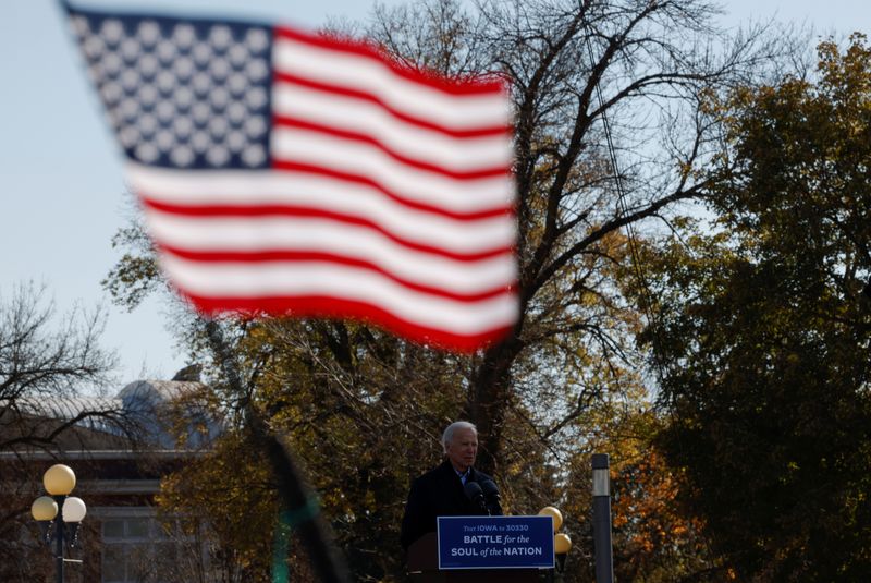 &copy; Reuters. A U.S. flag flies as Democratic U.S. presidential nominee and former Vice President Joe Biden speaks during a drive-in campaign stop, in Des Moines, Iowa, U.S., October 30, 2020.   REUTERS/Brian Snyder/File Photo