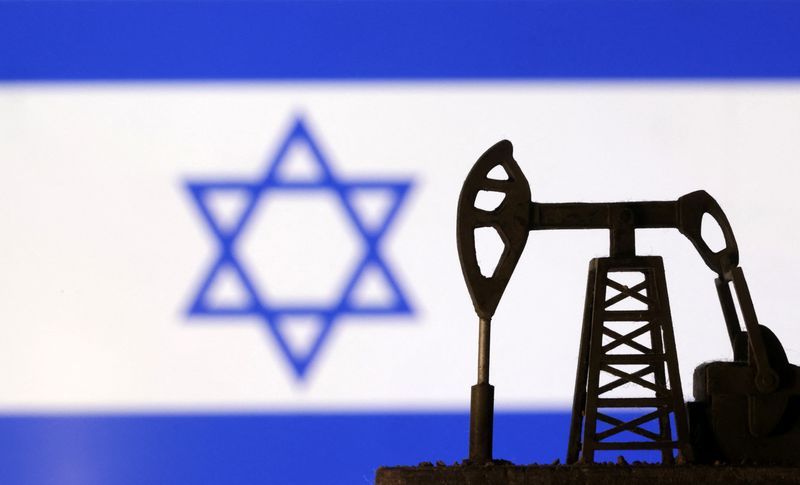 &copy; Reuters. Una pompa petrolifera di fronte ad una bandiera israeliana. 8 ottobre 2023. REUTERS/Dado Ruvic/Illustration