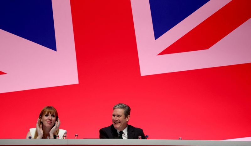 &copy; Reuters. Britain’s Labour Party leader Keir Starter and Deputy Leader Angela Rayner listen to Shadow Chancellor of the Exchequer Rachel Reeves during her keynote speech during the Labour Party annual conference in Liverpool, Britain, October 9, 2023. REUTERS/Phi