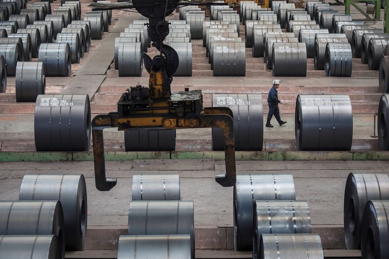 &copy; Reuters. FILE PHOTO: A worker walks past steel rolls at the Chongqing Iron and Steel plant in Changshou, Chongqing, China August 6, 2018. Picture taken August 6, 2018. REUTERS/Damir Sagolj/File photo