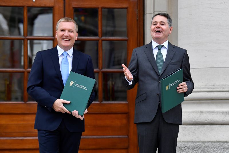 &copy; Reuters. Ireland's Minister for Finance Paschal Donohoe and Minister for Public Expenditure and Reform Michael McGrath hold the Budget 2022 documents in the courtyard of Government Buildings, Dublin, Ireland, October 12, 2021. REUTERS/Clodagh Kilcoyne/ File Photo