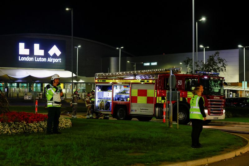 &copy; Reuters. A fire truck is parked outside the main terminal building as emergency services respond to a fire in Terminal Car Park 2 at London Luton airport in Luton, Britain, October 10, 2023.  REUTERS/Peter Cziborra