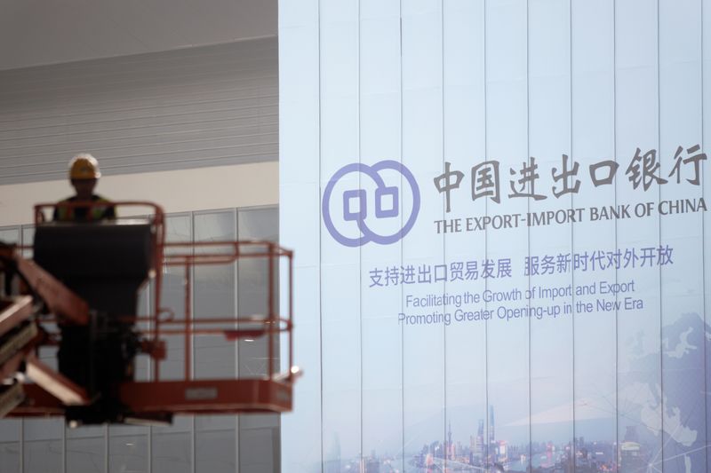 &copy; Reuters. FILE PHOTO: A worker is seen near a sign of the Export-Import Bank of China at the venue for the second China International Import Expo (CIIE) in Shanghai, China October 31, 2019. Picture taken October 31, 2019. REUTERS/Stringer/File photo
