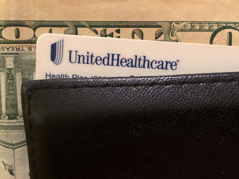 © Reuters. FILE PHOTO: A UnitedHealth Group health insurance card is seen in a wallet in this picture illustration October 14, 2019. REUTERS/Lucy Nicholson/Illustration/File Photo