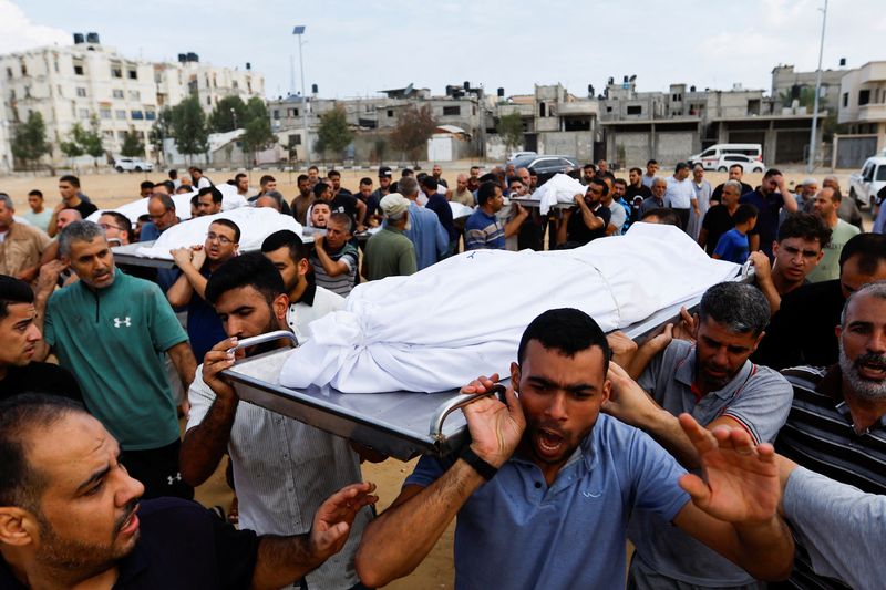 © Reuters. مشيعون يحملون جثث أفراد عائلة الأغا الفلسطينية الذين قتلوا في غارات إسرائيلية في خان يونس بجنوب قطاع غزة يوم 11 أكتوبر تشرين الأول 2023. تصوير: إبراهيم أبو مصطفى - رويترز.