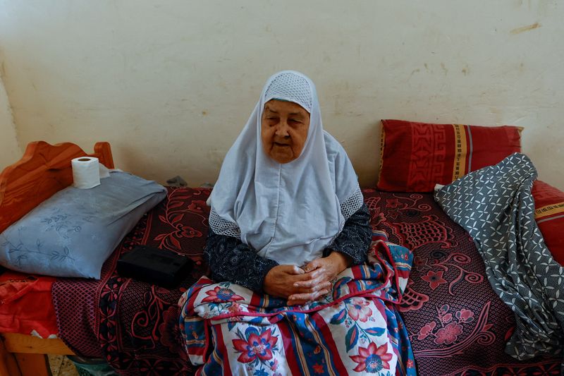 © Reuters. Palestinian woman Fawzeya Shaheen, 90, who lived through all Israeli-Palestinian wars dating back to 1948, sits at her home, amid the ongoing Israeli-Palestinian conflict, in Khan Younis in the southern Gaza Strip October 14, 2023. REUTERS/Ibraheem Abu Mustafa
