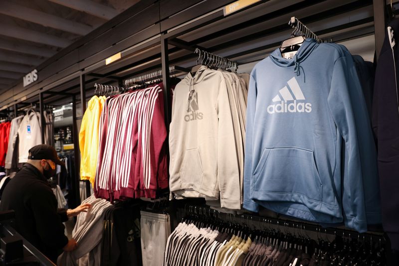 © Reuters. A person looks at clothes in the Adidas store at the Woodbury Common Premium Outlets in Central Valley, New York, U.S., February 15, 2022. REUTERS/Andrew Kelly