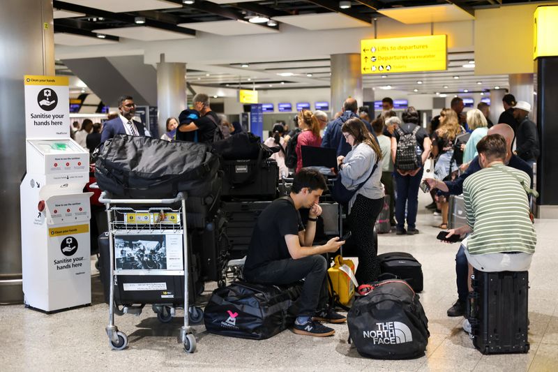 &copy; Reuters. Travellers wait near the British Airways check-in area at Heathrow Airport, as Britain's National Air Traffic Service (NATS) restricts UK air traffic due to a technical issue causing delays, in London, Britain, August 28, 2023. REUTERS/Hollie Adams/File P