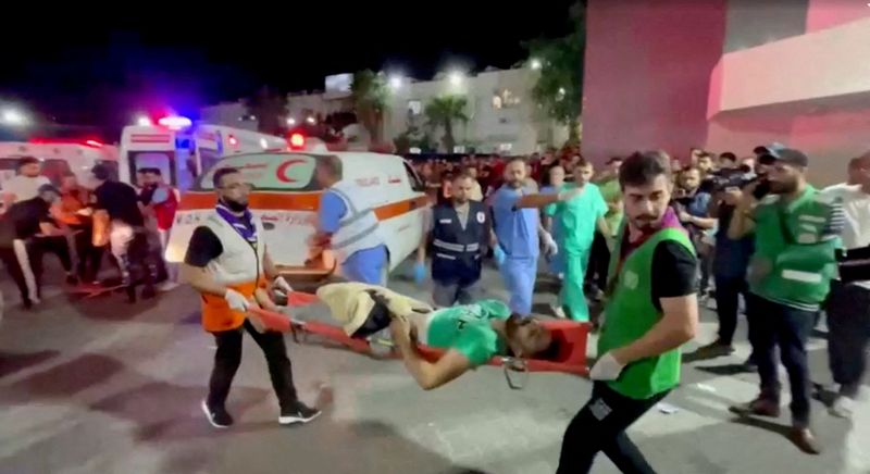 &copy; Reuters. An injured person is taken into a hospital after hundreds of Palestinians were killed in a blast at Al-Ahli hospital in Gaza that Israeli and Palestinian officials blamed on each other in Gaza City, Gaza Strip, in this screen grab obtained from video, Oct