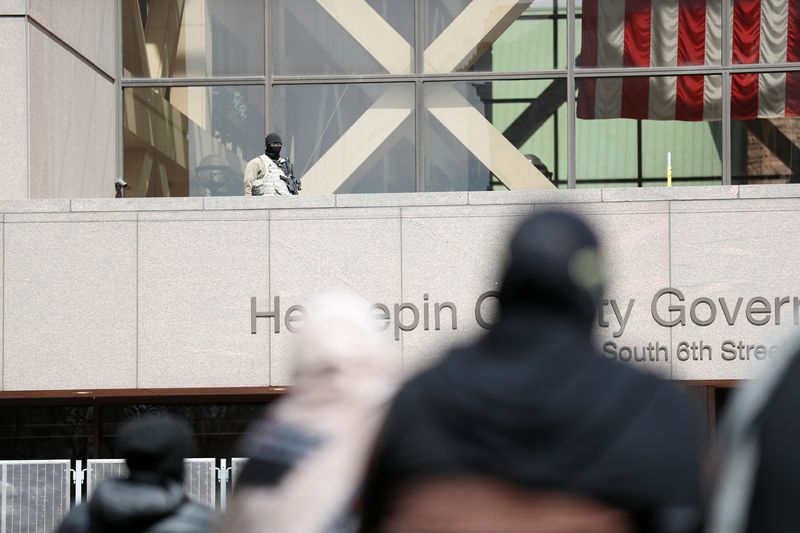 &copy; Reuters. A member of the National Guard watches over the Minnesota Chapter of the Council on American-Islamic Relations while Friday prayers are underway at the Hennepin County Government Center, as protests continue days after former police officer Kim Potter kil