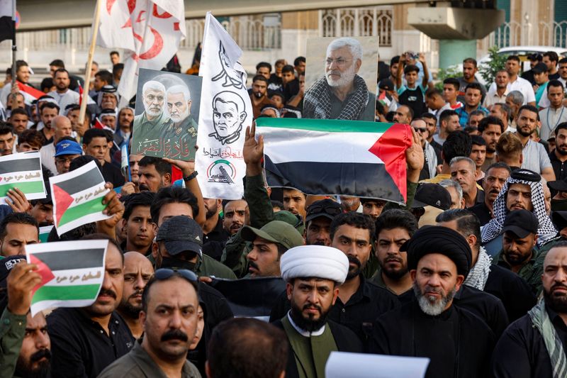 &copy; Reuters. أشخاص يحملون الأعلام الفلسطينية أثناء مشاركتهم في احتجاج لدعم الفلسطينيين في غزة بمدينة النجف في العراق يوم الجمعة. تصوير: علاء المرجاني - ر